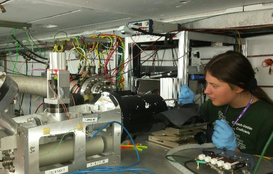 Robin Bjorkquist surrounded by equipment in a lab at SLAC.